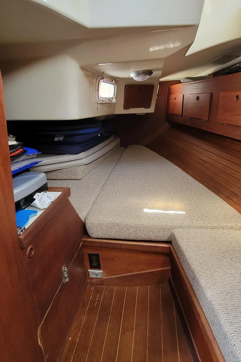 Slide: The Image of 1988 Sabre 38 MkII sailboat interior cabin with wooden finishes and cushioned seating. - 30