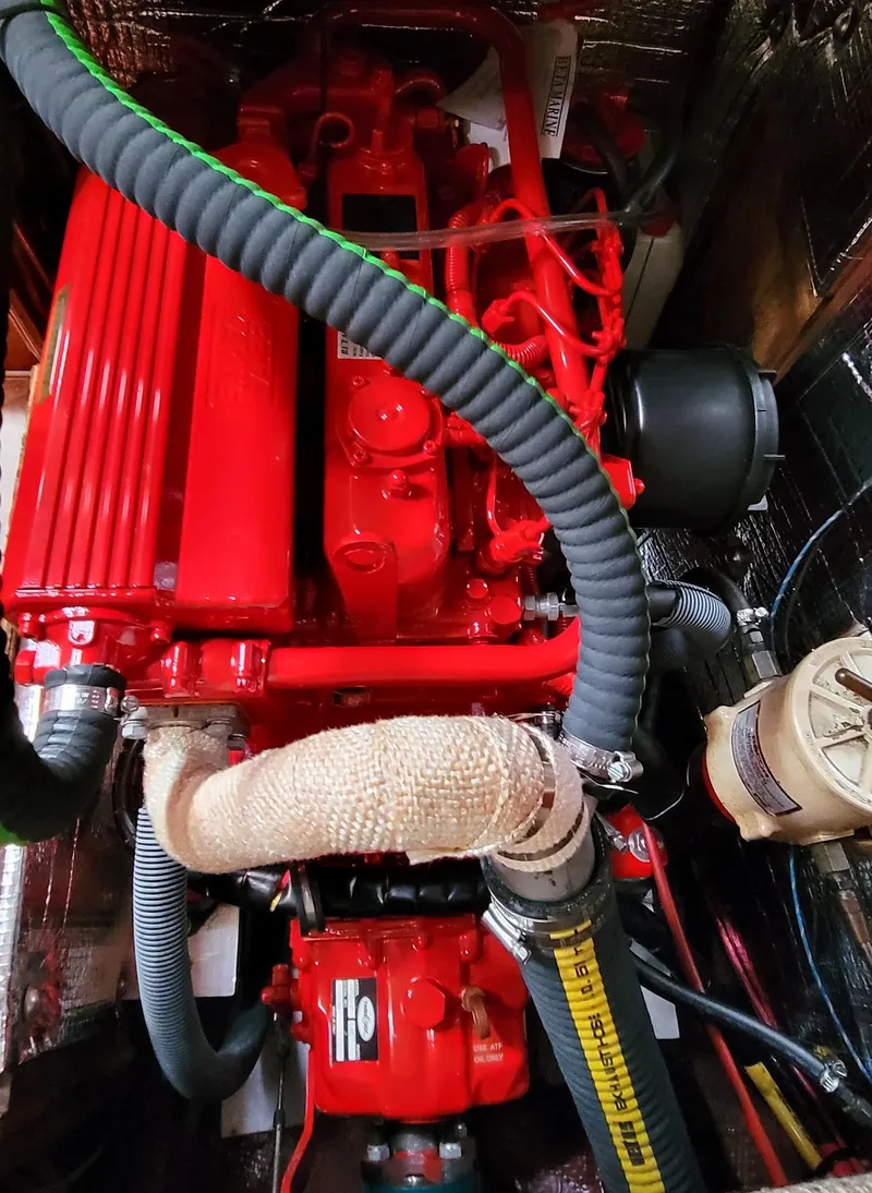 Slide: The Image of 1988 Sabre 38 MkII engine compartment with red marine engine and hoses - 34