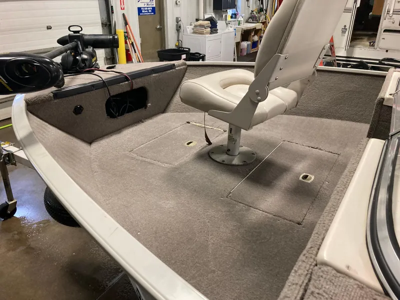 Slide: The Image of 2002 Sylvan 1600 Expedition DC boat interior with swivel seat and storage compartments. - 6