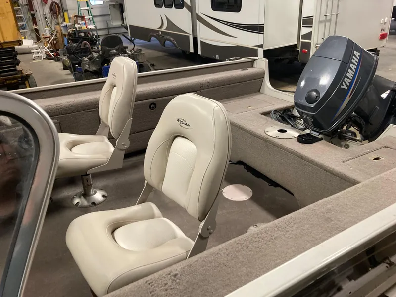 Slide: The Image of 2002 Sylvan 1600 Expedition DC boat interior with Yamaha outboard motor. - 7