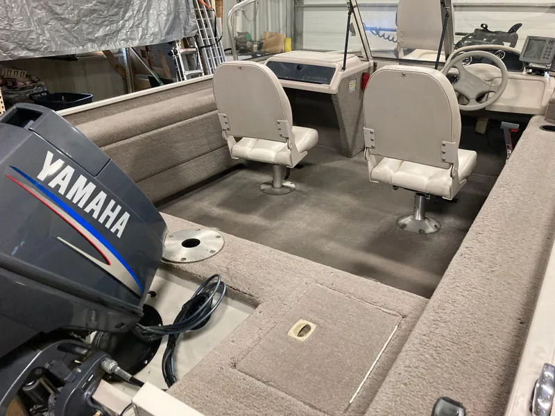 Slide: The Image of 2002 Sylvan 1600 Expedition DC boat interior with Yamaha outboard motor. - 8