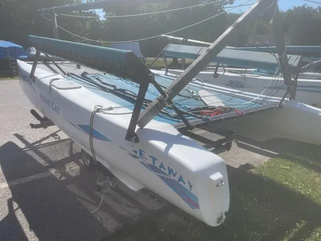 Slide: The Image of 2004 Hobie Getaway catamaran sailboat on a trailer in a sunny outdoor setting. - 3
