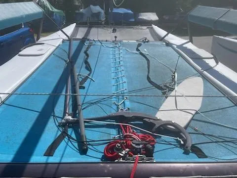 Slide: The Image of 2004 Hobie Getaway catamaran sailboat with blue trampoline and rigging. - 4