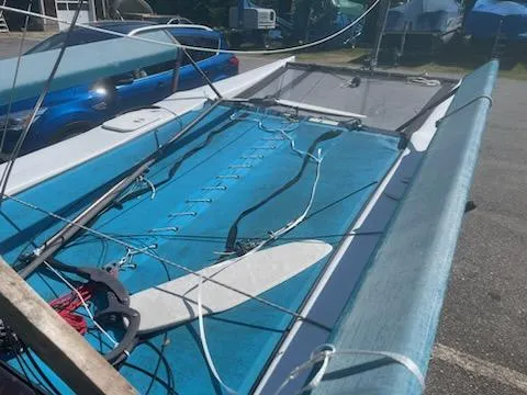 Slide: The Image of 2004 Hobie Getaway catamaran sailboat on trailer, blue trampoline, rigging visible. - 5