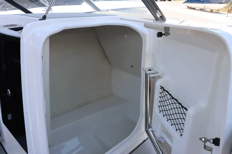 Slide: The Image of 2024 Yamaha Boats AR250 storage compartment with netted pocket and stainless steel hardware. - 11