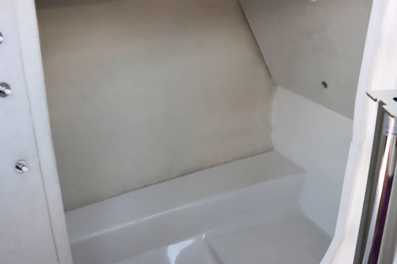 Slide: The Image of Interior cabin of 2024 Yamaha Boats AR250, featuring clean white surfaces. - 12