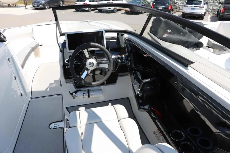 Slide: The Image of 2024 Yamaha Boats AR250 helm with steering wheel, touchscreen display, and comfortable seating. - 14