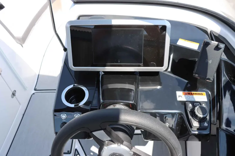 Slide: The Image of 2024 Yamaha Boats AR250 dashboard with touchscreen, steering wheel, and control panel. - 15
