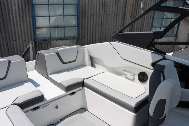 Slide: The Image of Interior seating of 2024 Yamaha Boats AR250, featuring modern white and gray upholstery. - 6