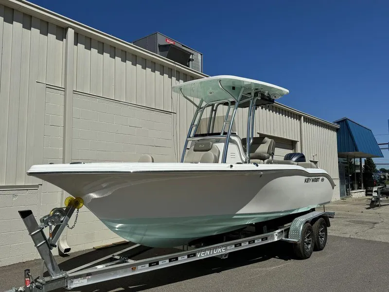 Slide: The Image of 2024 Key West 219 FS boat on trailer outside a building. - 1