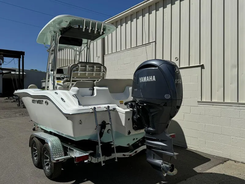 Slide: The Image of 2024 Key West 219 FS boat with Yamaha 150 outboard motor on trailer. - 2