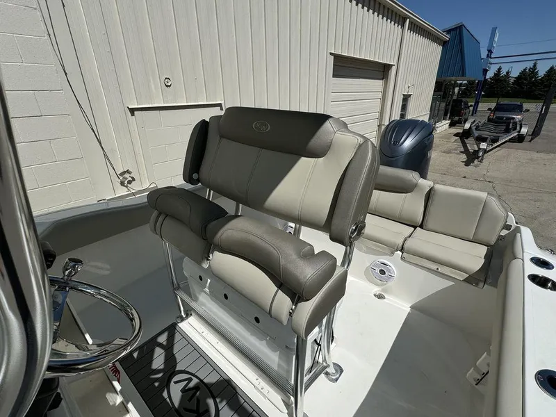 Slide: The Image of 2024 Key West 219 FS boat interior with seating and steering wheel. - 5