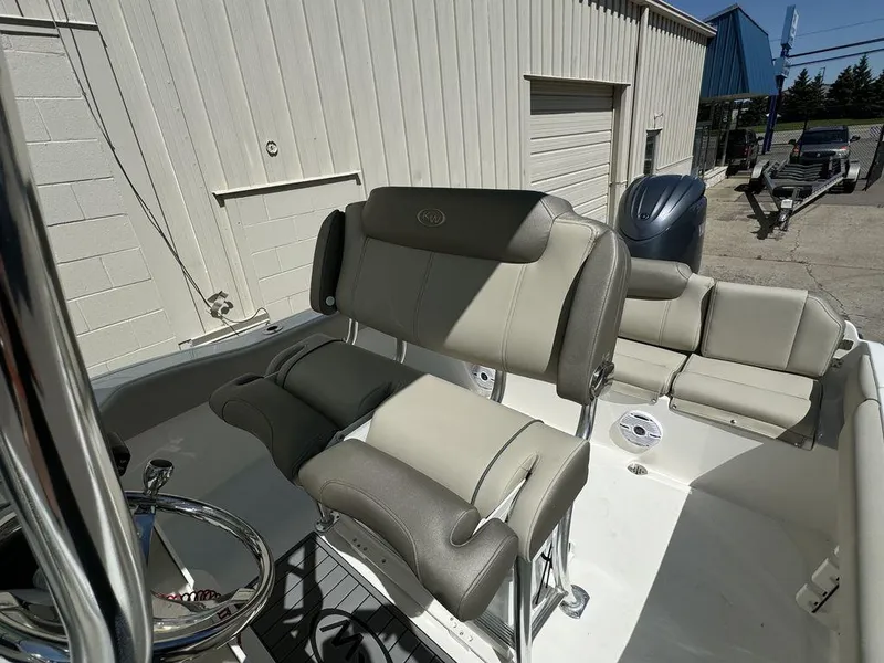 Slide: The Image of 2024 Key West 219 FS boat interior with cushioned seating and steering wheel. - 6