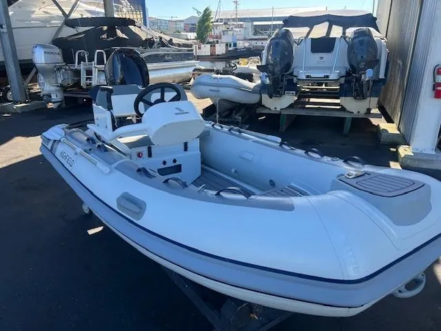 Slide: The Image of 2024 Highfield CL340 FCT inflatable boat in a marina. - 4