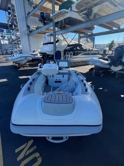 Slide: The Image of 2024 Highfield CL340 FCT inflatable boat in a marina storage area. - 7