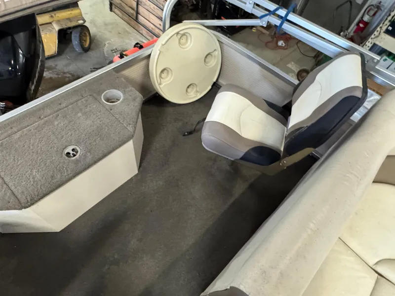 Slide: The Image of 2010 Crestliner Batata Bay 2185 interior with seating and storage compartments. - 11