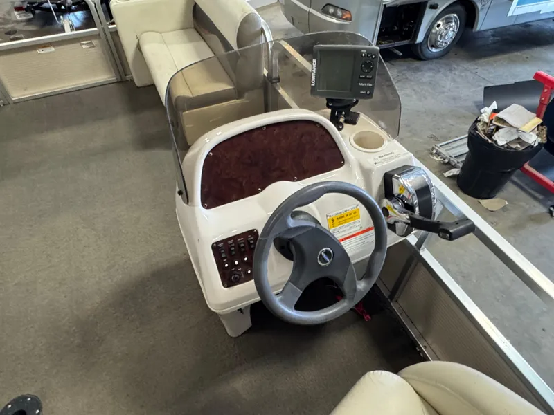 Slide: The Image of 2010 Crestliner Batata Bay 2185 boat console with steering wheel and control panel. - 13