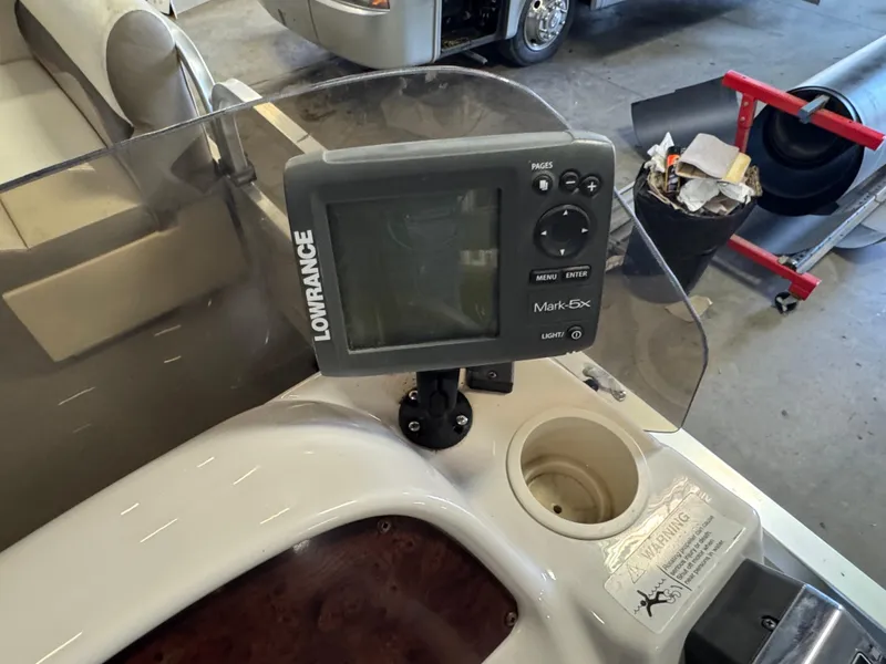 Slide: The Image of Fishfinder on 2010 Crestliner Batata Bay 2185 boat dashboard in a garage setting. - 14