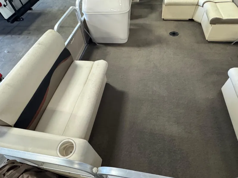 Slide: The Image of 2010 Crestliner Batata Bay 2185 interior with beige seating and carpeted floor. - 5