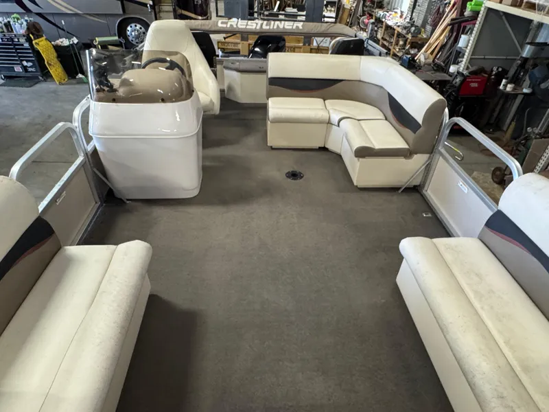 Slide: The Image of 2010 Crestliner Batata Bay 2185 pontoon boat interior with spacious seating and helm. - 6