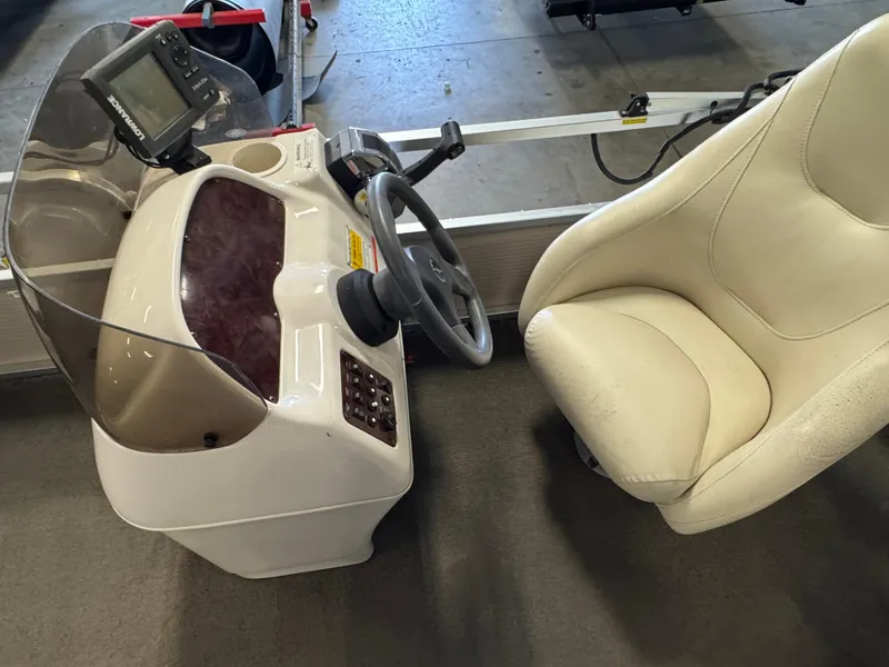 Slide: The Image of 2010 Crestliner Batata Bay 2185 boat console with steering wheel and cushioned seat. - 9