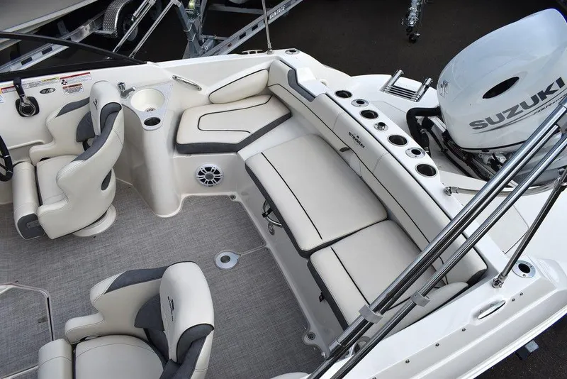 Slide: The Image of 2024 Stingray 201DC boat interior with Suzuki engine, featuring plush seating and modern design. - 10