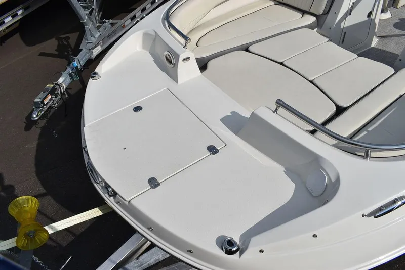 Slide: The Image of 2024 Stingray 201DC boat interior with cushioned seating and storage compartments. - 13