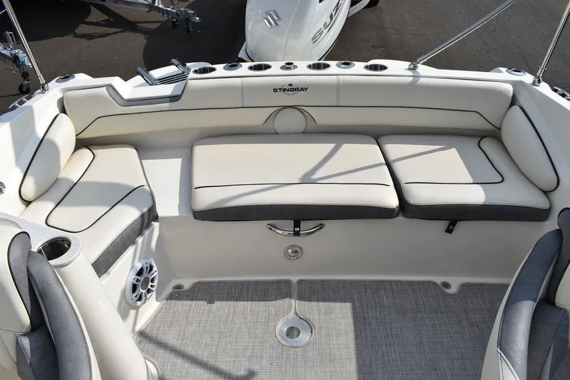 Slide: The Image of 2024 Stingray 201DC boat interior with cushioned seating and modern design. - 17