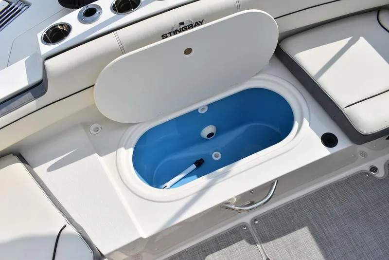 Slide: The Image of 2024 Stingray 201DC boat with open storage compartment and seating area. - 20