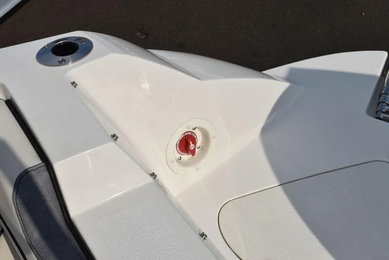 Slide: The Image of 2024 Stingray 201DC boat deck with red safety switch and cup holder. - 25