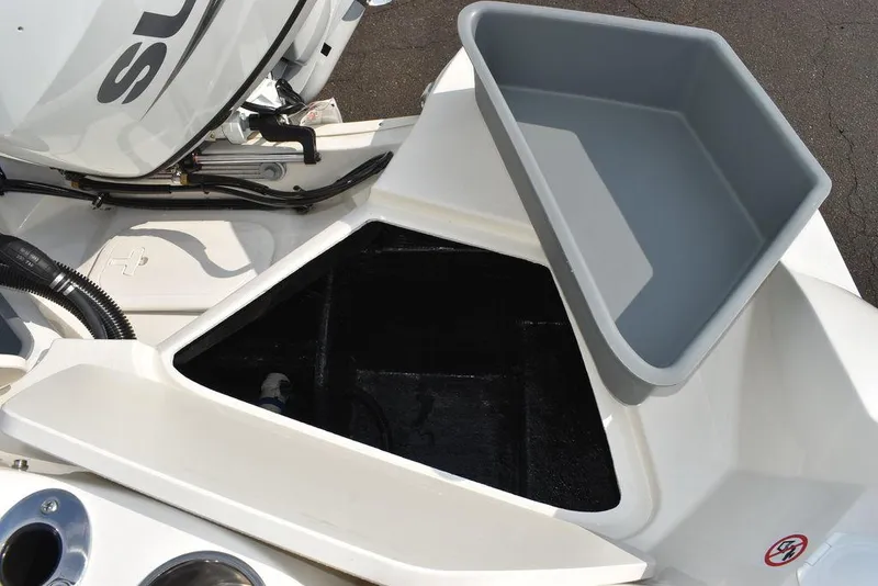 Slide: The Image of 2024 Stingray 201DC boat storage compartment with open lid, showcasing interior space. - 26