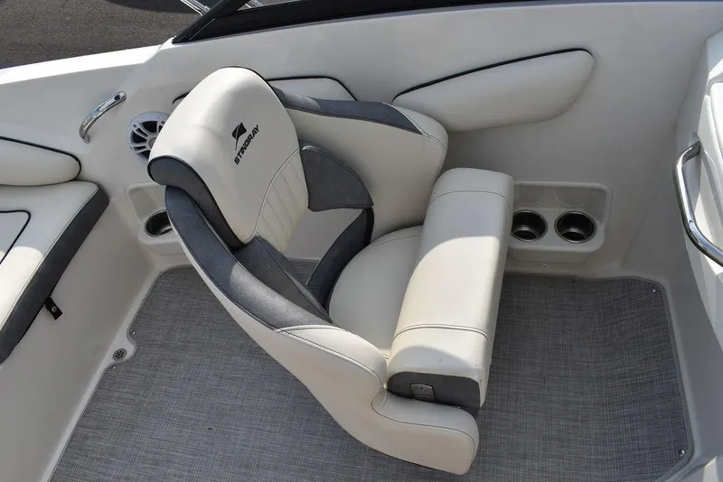 Slide: The Image of 2024 Stingray 201DC boat interior with plush seating and cup holders. - 30