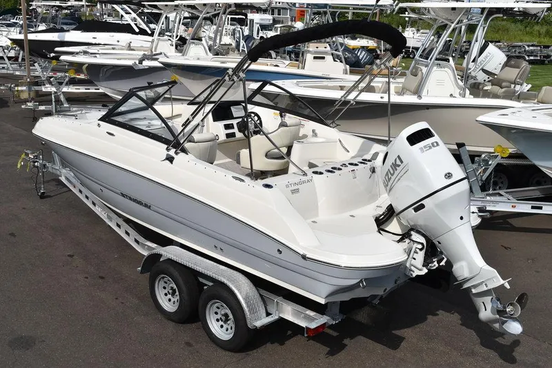Slide: The Image of 2024 Stingray 201DC boat on trailer with Yamaha outboard motor. - 4