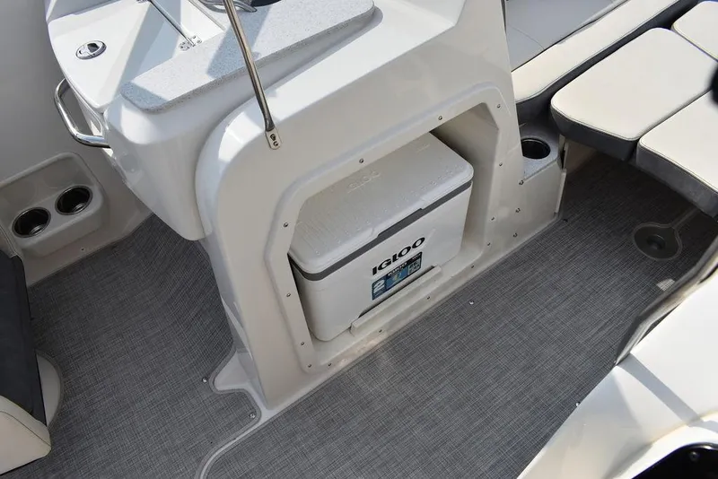 Slide: The Image of 2024 Stingray 201DC boat interior with Igloo cooler and seating area. - 41