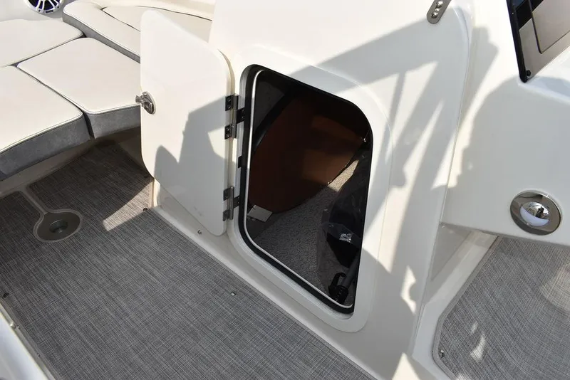 Slide: The Image of 2024 Stingray 201DC boat interior with open storage compartment and seating area. - 43