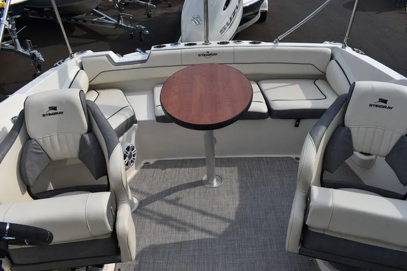 Slide: The Image of 2024 Stingray 201DC boat interior with seating and table, featuring modern design and comfort. - 45