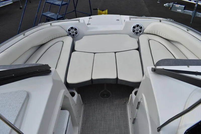Slide: The Image of 2024 Stingray 201DC boat interior with cushioned seating and speakers. - 47
