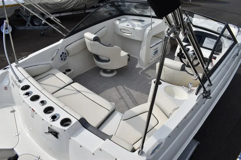 Slide: The Image of 2024 Stingray 201DC boat interior with white seating and modern dashboard. - 8