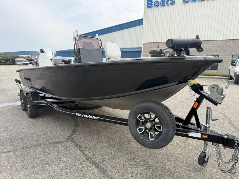Slide: The Image of 2023 Polar Kraft Outlander 2010 CC boat on trailer, parked outside dealership. - 1