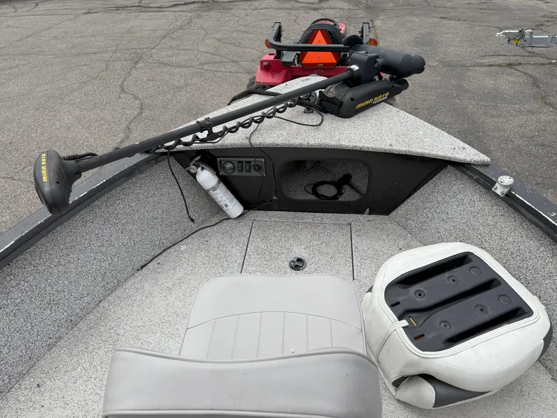 Slide: The Image of 2023 Polar Kraft Outlander 2010 CC boat interior with seating and trolling motor. - 11