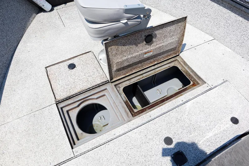 Slide: The Image of Open storage compartments on a 2023 Polar Kraft Outlander 2010 CC boat. - 14