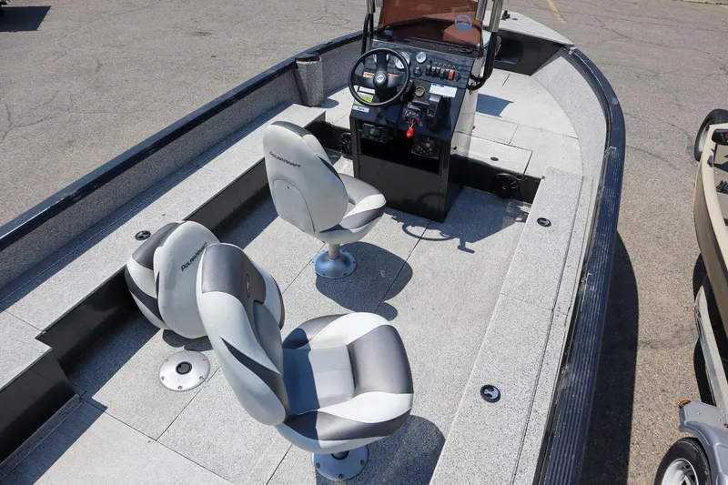 Slide: The Image of 2023 Polar Kraft Outlander 2010 CC boat interior with steering console and seating. - 5