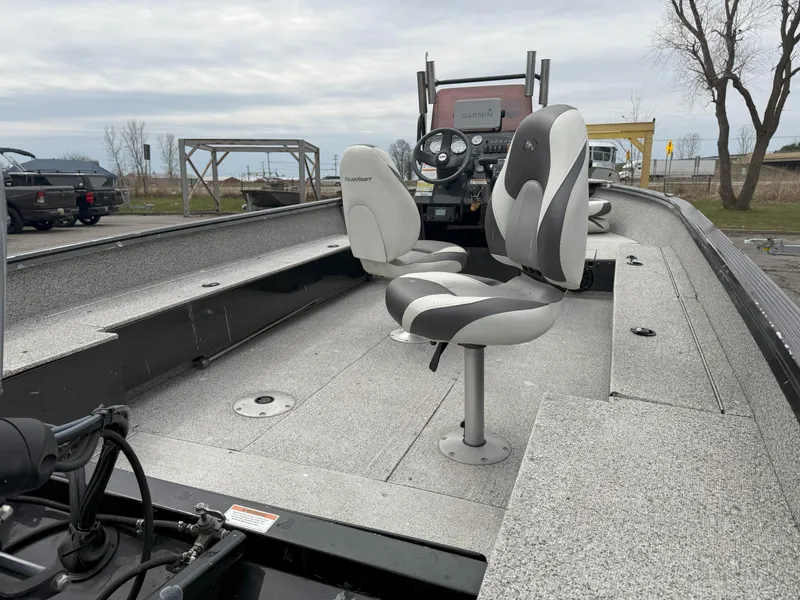 Slide: The Image of 2023 Polar Kraft Outlander 2010 CC boat interior with seating and steering console. - 8