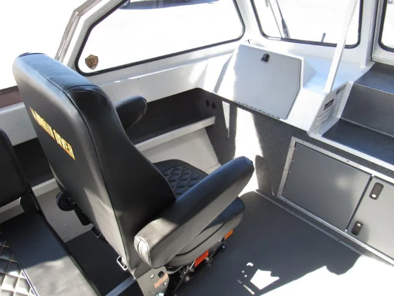 Slide: The Image of Interior of 2024 North River 23 SEAHAWK RTF boat with black seating and storage compartments. - 13