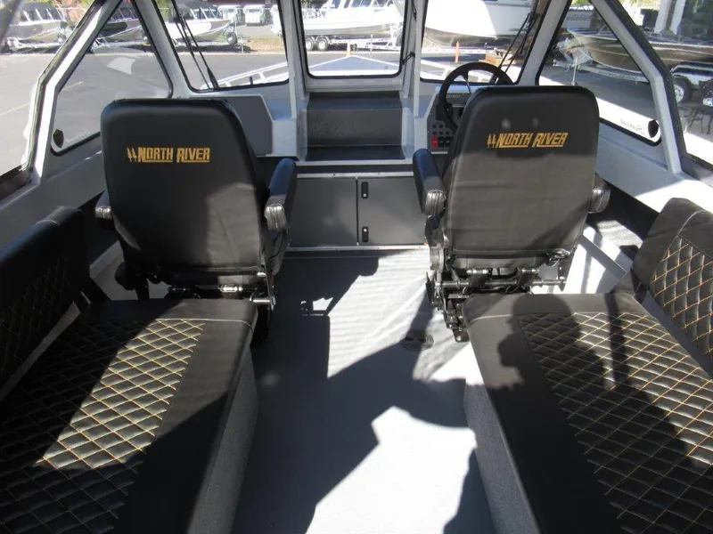Slide: The Image of Interior of 2024 North River 23 Seahawk RTF boat with black seats and steering console. - 16