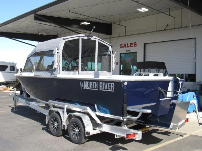 Slide: The Image of 2024 North River 23 Seahawk RTF boat on a trailer outside a sales building. - 3