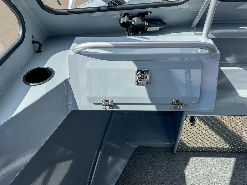 Slide: The Image of 2024 Hewescraft 200 Sportsman interior, featuring storage compartment and cup holder. - 10