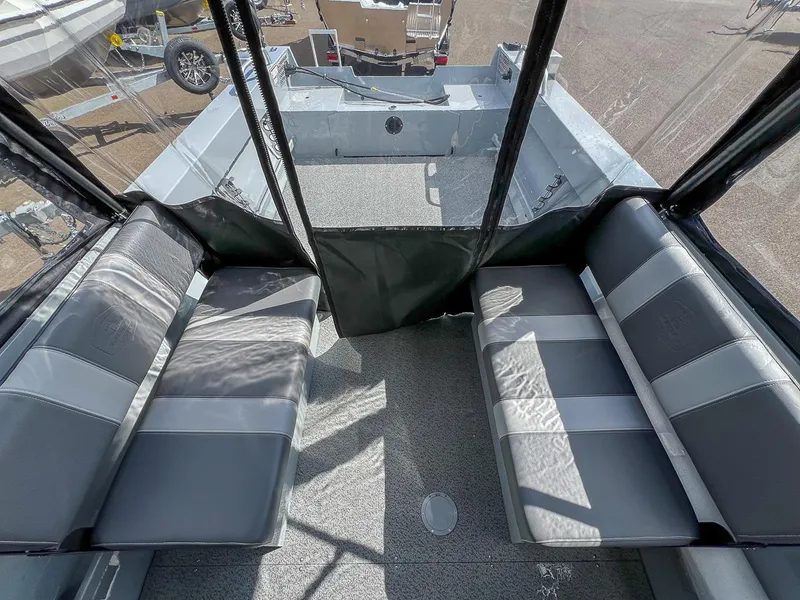 Slide: The Image of Interior of 2024 Hewescraft 200 Sportsman boat with seating and clear canopy. - 13