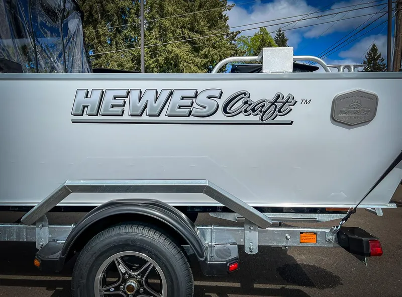 Slide: The Image of 2024 Hewescraft 200 Sportsman boat on trailer, side view with logo. - 18