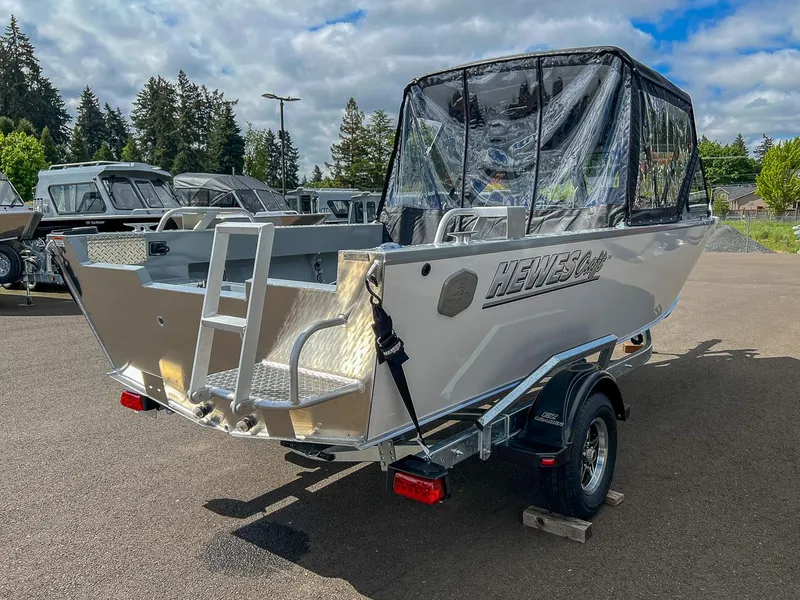 Slide: The Image of 2024 Hewescraft 200 Sportsman boat with canopy, parked on a trailer. - 5